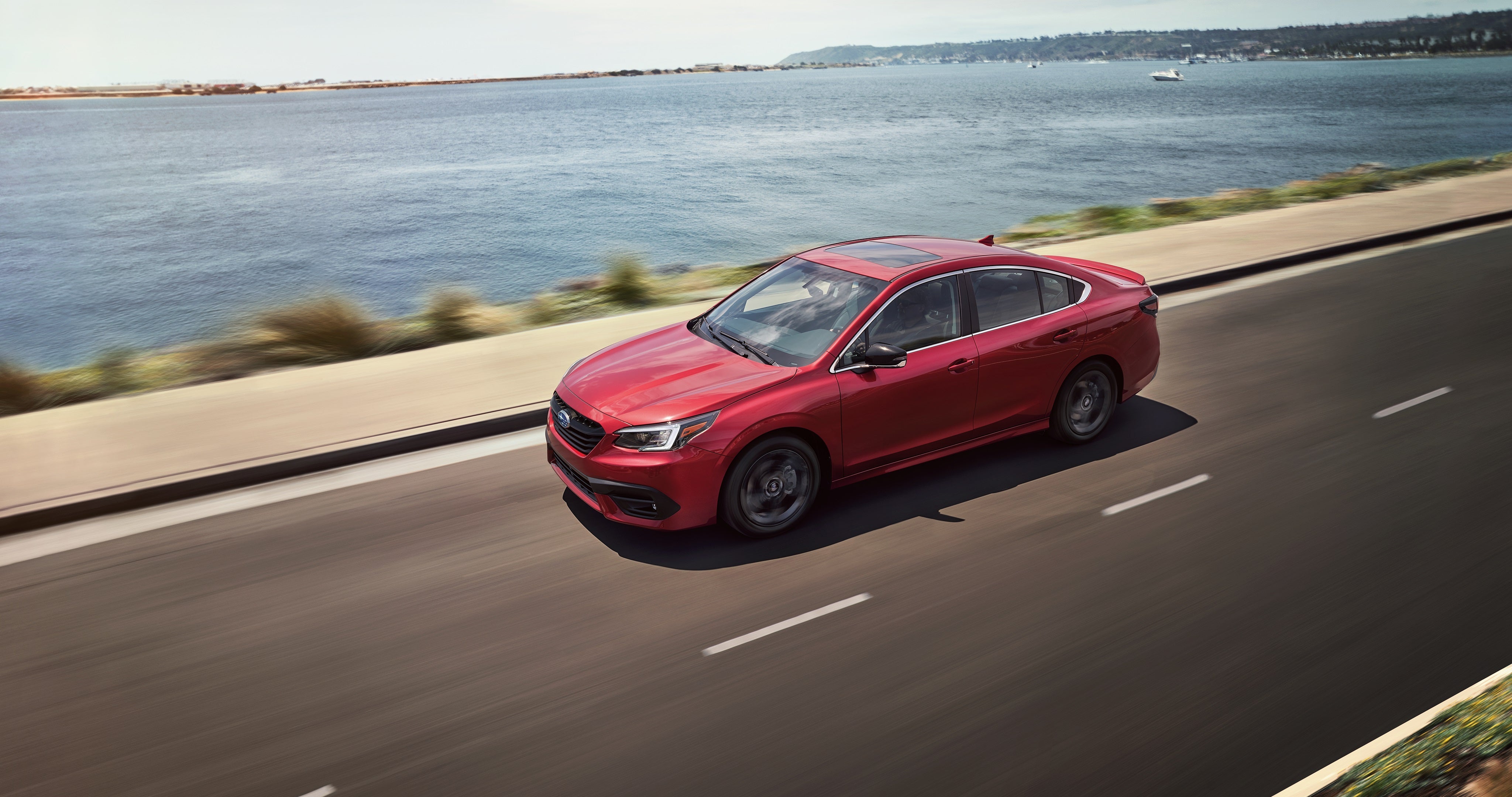 2021 Legacy vehicle driving away from city on highway