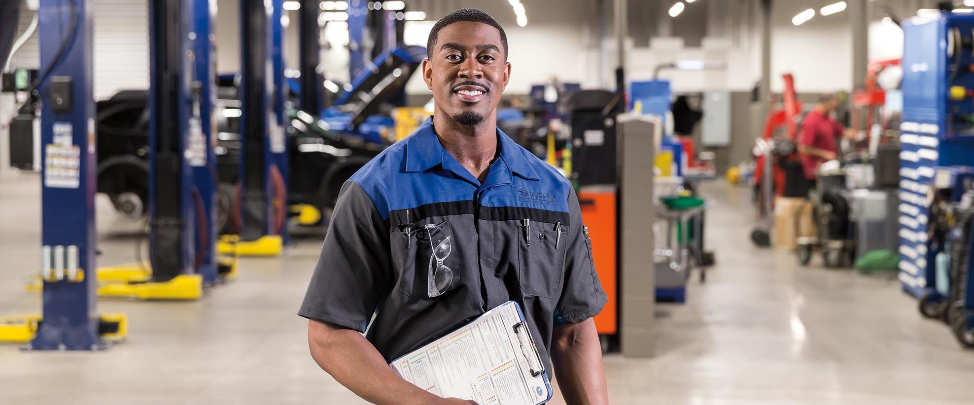 Image of service representative smiling and holding clipboard
