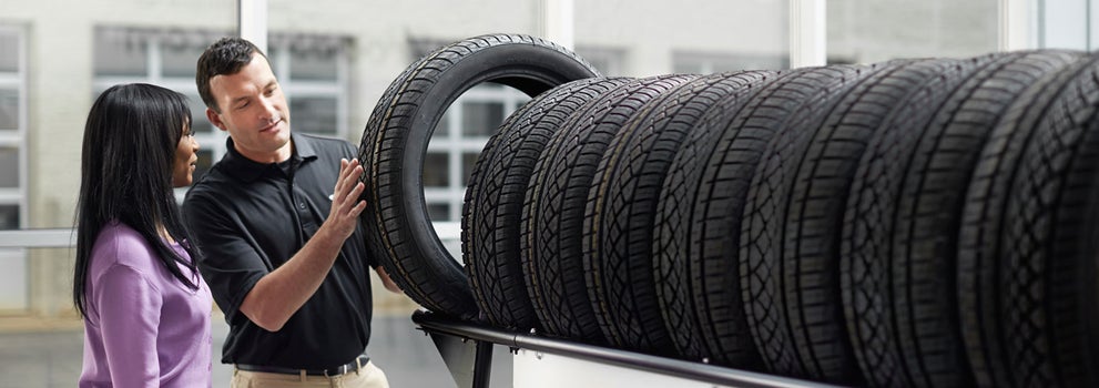 Subaru service representative showing customer a tire. | SubaruDemo1 in Conway NH